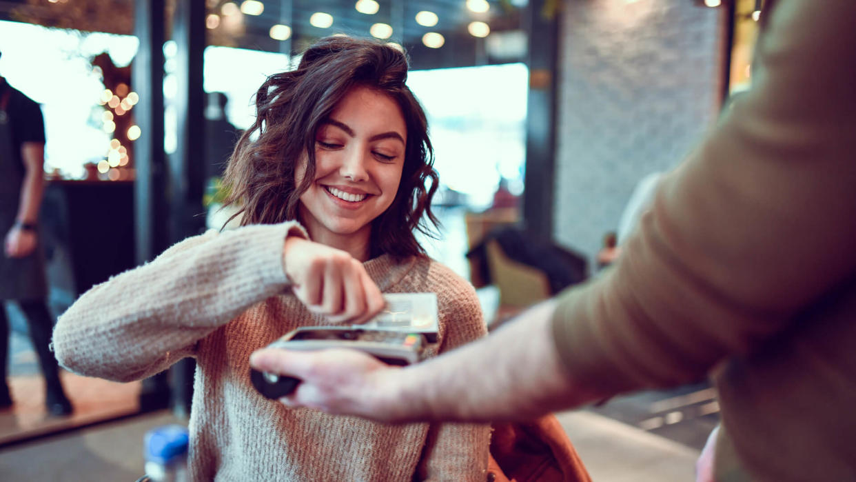 Female Paying With Credit Card In Restaurant.