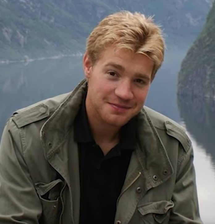 Photo of Lars with blonde hair wearing a green army jacket