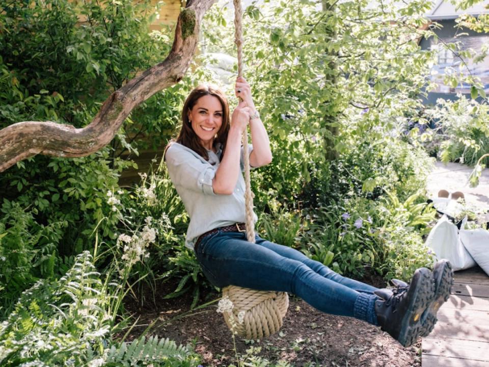 Kate Middleton swings on a swing at RHS Back to Nature garden in 2019.
