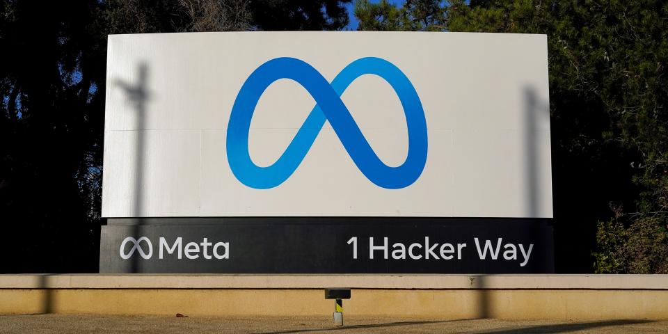 Meta's logo on a sign for "1 Hacker Way" outside the company's headquarters.