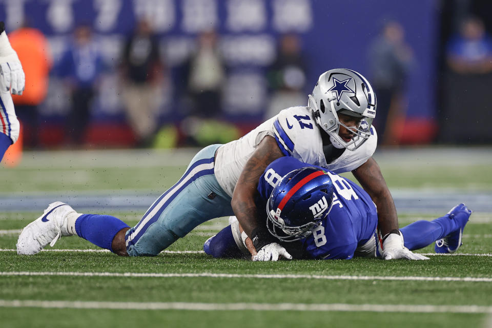 Dallas Cowboys' Micah Parsons (11), top, tackles New York Giants quarterback Daniel Jones during the first half of an NFL football game, Sunday, Sept. 10, 2023, in East Rutherford, N.J. (AP Photo/Adam Hunger)