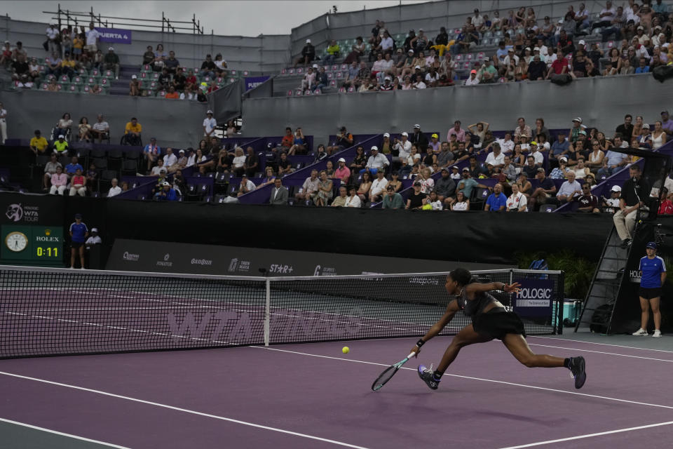 Coco Gauff of the United States returns a shot to Marketa Vondrousova, of the Czech Republic, during a women's singles match at the WTA Finals tennis championships, in Cancun, Mexico, Friday, Nov. 3, 2023. (AP Photo/Fernando Llano)