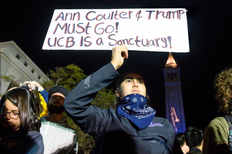 University of California, Berkeley student Magaly Mercado holds a protest sign as attendees leave a speech by conservative commentator Ann Coulter on Wednesday, Nov. 20, 2019, in Berkeley, Calif.