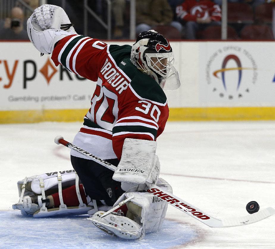 New Jersey Devils goalie Martin Brodeur makes a save on a shot by the Boston Bruins during the first period of an NHL hockey game, Tuesday, March 18, 2014, in Newark, N.J. (AP Photo/Julio Cortez)