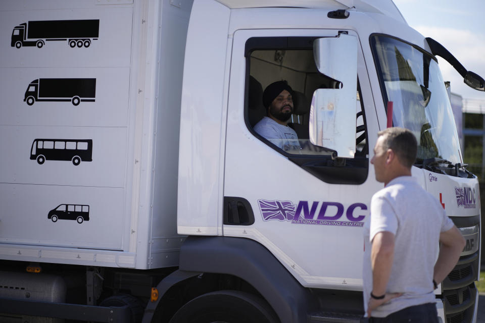 An instructor watches as a learner truck driver practices reversing at the National Driving Centre in Croydon, south London, Wednesday, Sept. 22, 2021. Britain doesn't have enough truck drivers. The shortage is contributing to scarcity of everything from McDonald's milkshakes to supermarket produce. (AP Photo/Matt Dunham)