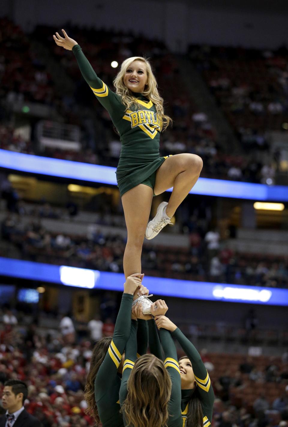 A Baylor cheerleader performs during a regional semifinal NCAA college basketball tournament game against Wisconsin, Thursday, March 27, 2014, in Anaheim, Calif. (AP Photo/Jae C. Hong)