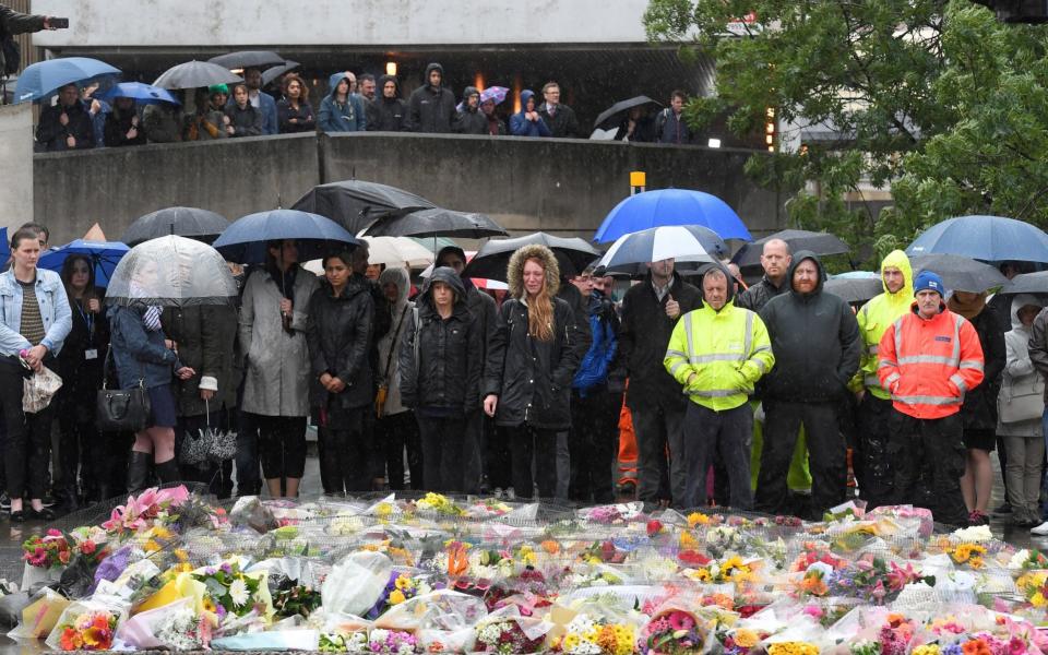 People near the scene of the recent attack observe a minute's silence - Credit: REUTERS/Toby Melville