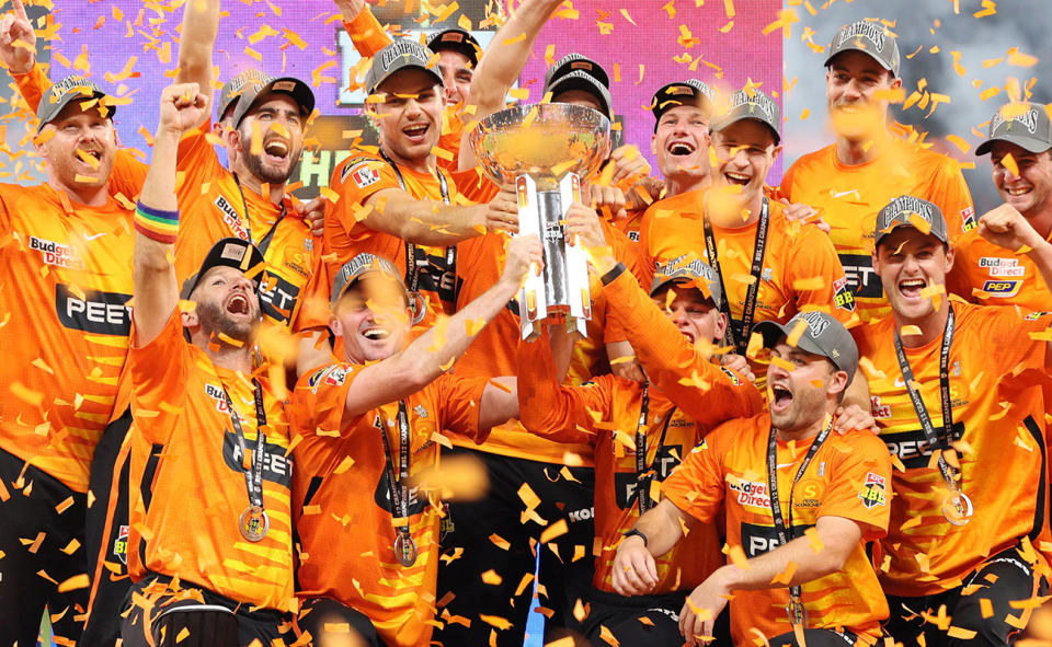 Perth Scorchers players, pictured here celebrating with the trophy after the BBL final.