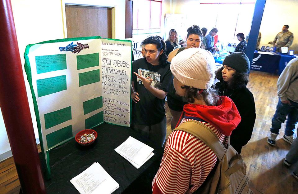 ACCA students Allen Bacon and Bailey Anderson talk with students Jacob Keener and Jamie Kendall about the credentialing program project for final grade requirements they were involved in, which was gathering and putting together a list of hotline phone numbers to distribute.