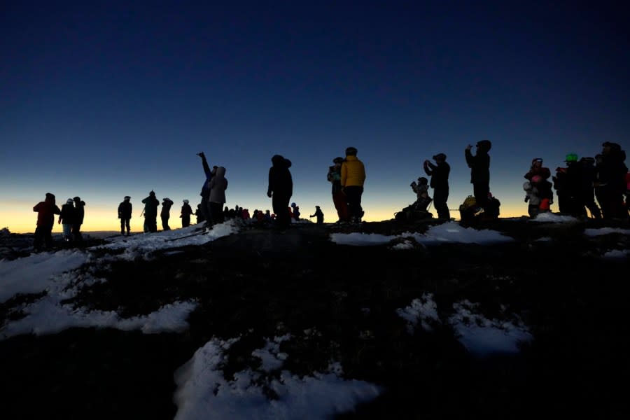 Skiers and hikers watch the total eclipse of the sun from the Appalachian Trail at the summit of Saddleback Mountain, Monday, April 8, 2024, near Rangeley, Maine. (AP Photo/Robert F. Bukaty)