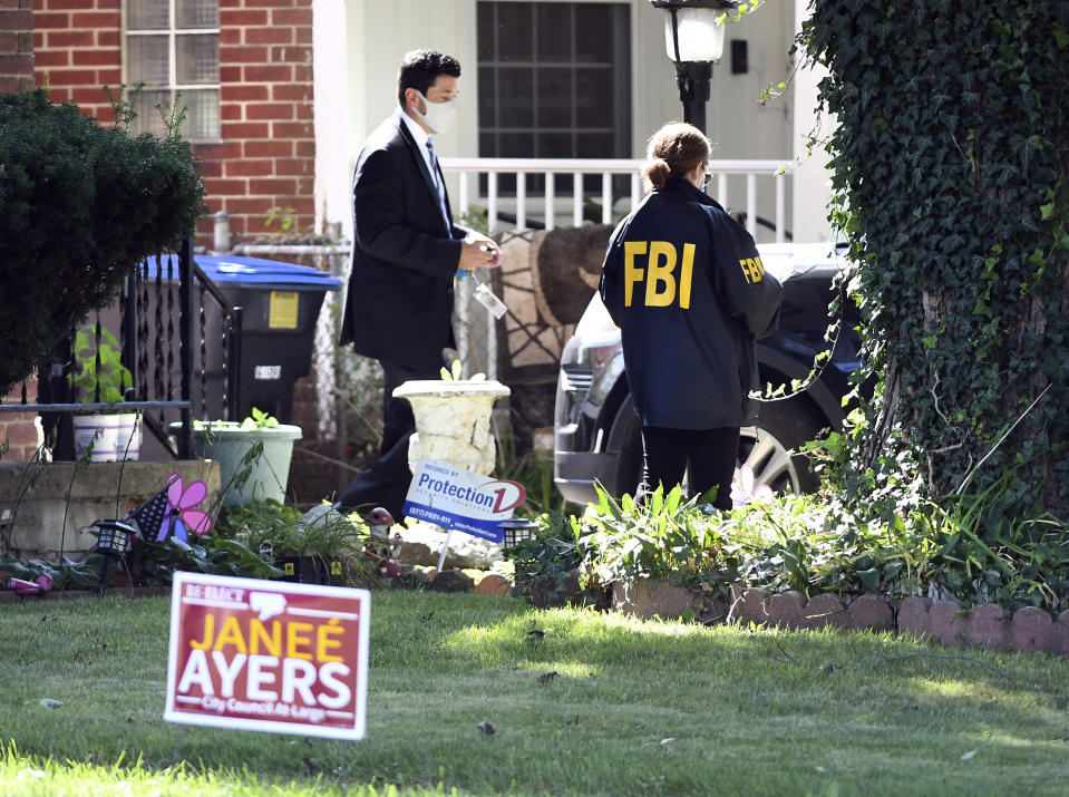 FBI investigators search the home of Detroit Council member Janee Ayers, Wednesday, Aug. 25, 2021, in Detroit. Federal agents searched the homes of two Detroit City Council members, Ayers and Scott Benson, and city offices Wednesday, just a few weeks after another official was charged in an alleged bribery scheme. (Max Ortiz/Detroit News via AP)