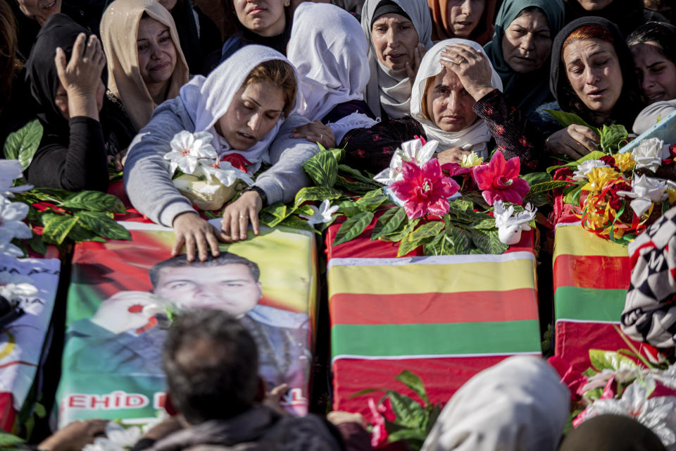 FILE -- Syrian Kurds attend a funeral of people killed in Turkish airstrikes in the village of Al Malikiyah , northern Syria, Monday, Nov. 21, 2022. Turkish airstrikes on northern Syria over the weekend that killed and wounded a number of Syrian soldiers could pose a setback to the recent move toward a rapprochement between the two countries after 11 years of tension and hostility. (AP Photo/Baderkhan Ahmad, File)