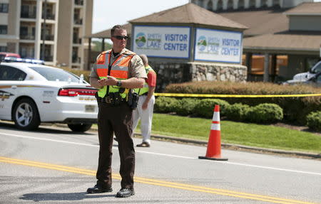 A law enforcement officer is seen on the road in front of the Bridgewater Plaza in Moneta, Virginia, August 26, 2015. REUTERS/Chris Keane