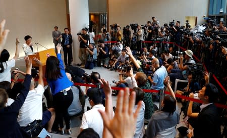 Journalists raise their arms to ask questions as Hong Kong's Chief Executive Carrie Lam holds a news conference in Hong Kong