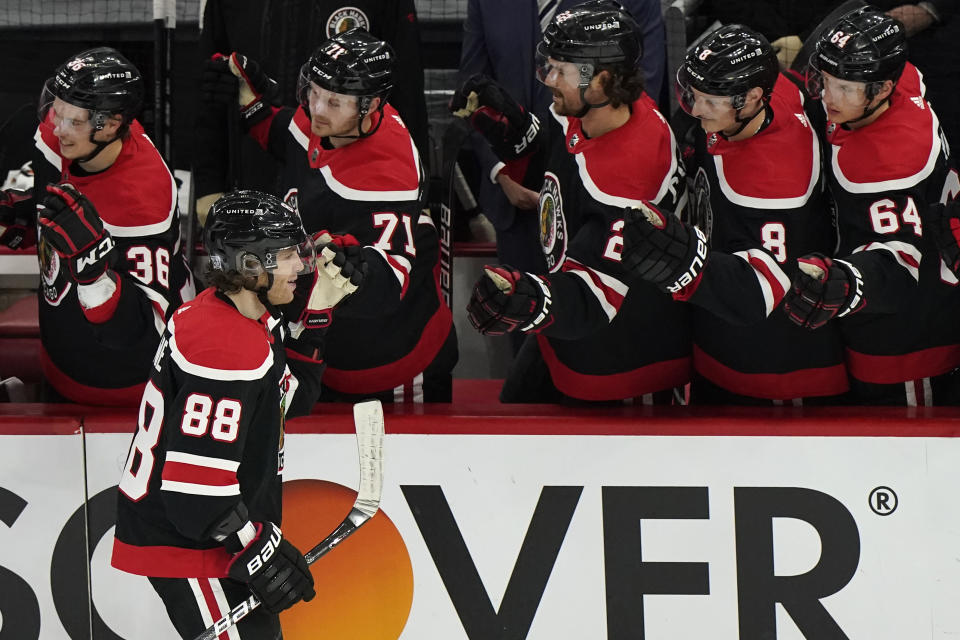 Chicago Blackhawks' Patrick Kane (88) celebrates with teammates after scoring a goal against the Detroit Red Wings during the third period of an NHL hockey game in Chicago, Sunday, Feb. 28, 2021. It was 400th goals from Patrick Kane. (AP Photo/Nam Y. Huh)