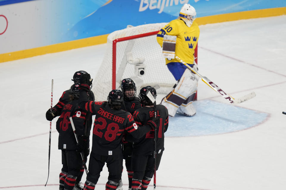 Canada celebrates a goal against Sweden during a women's quarterfinal hockey game at the 2022 Winter Olympics, Friday, Feb. 11, 2022, in Beijing. (AP Photo/Petr David Josek)