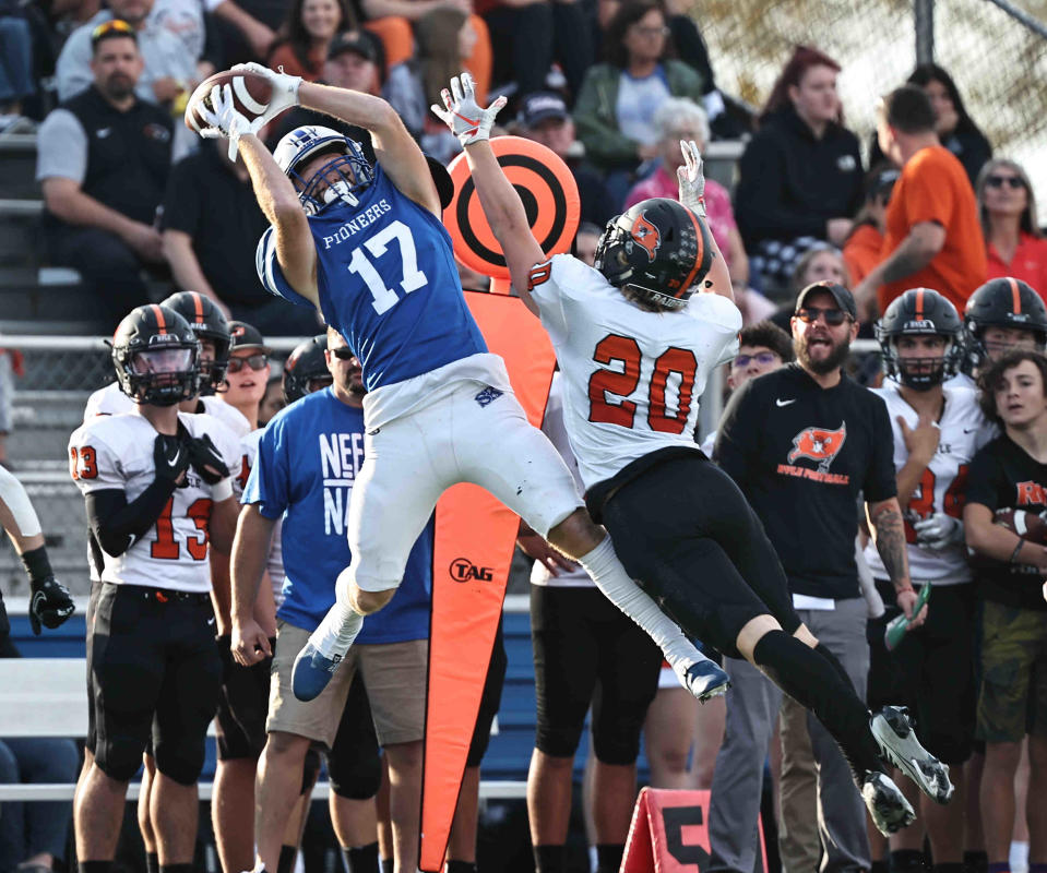 Simon Kenton wide receiver Chase Williams catches a pass over Ryle defensive back Jacob Savage during a football game Saturday.