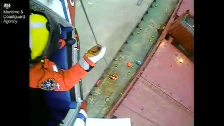 HM Coastguard Winchman Niall Hanson, is lowered down to the Kuzma Minin to assist the Harbour Pilot onboard, in Falmouth, Cornwall, Britain December 18, 2018 in this still image taken from a video obtained from social media. MARITIME & COASTGUARD AGENCY/via REUTERS