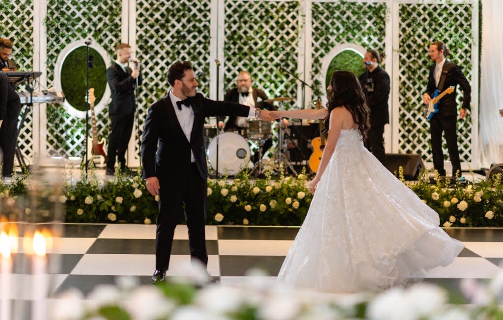 Mitchell and Nicole Cooper dance at their June wedding at The Country Club at Mirasol in Palm Beach Gardens.