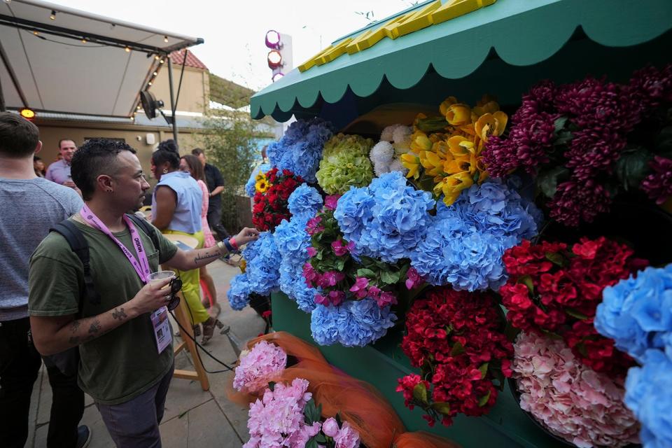 Johnny Moreno looks at a flower stand at Hotel San Jose for the "Y’all Are Welcome to Prime, TX" activation by Amazon Prime in the theme of "The Summer I Turned Pretty" during day one of South by Southwest Friday, March 10, 2023.