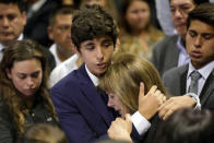 Federico Danton, son of Peru's former President Alan Garcia, hugs his mother Roxanne Cheesman during a wake for Garcia after he fatally shot himself on Wednesday, in Lima, Peru April 17, 2019. REUTERS/Guadalupe Pardo