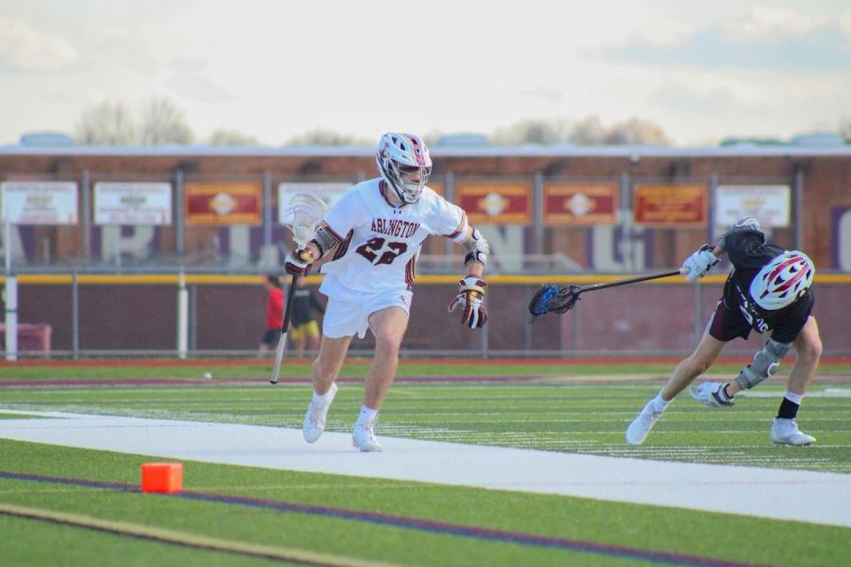 Arlington's Aidan Ward moves the ball up field against Ossining during an April 8, 2022 boys lacrosse game.