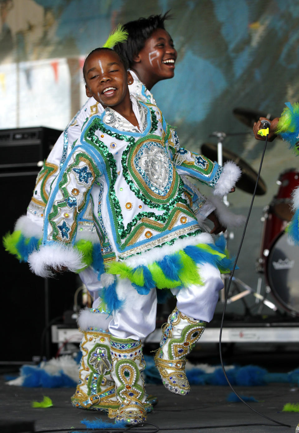 Members of Fi Yi Yi & the Mandingo Warriors, a Mardi Gras Indian tribe, perform at the New Orleans Jazz and Heritage Festival in New Orleans, Thursday, May 3, 2012. (AP Photo/Gerald Herbert)