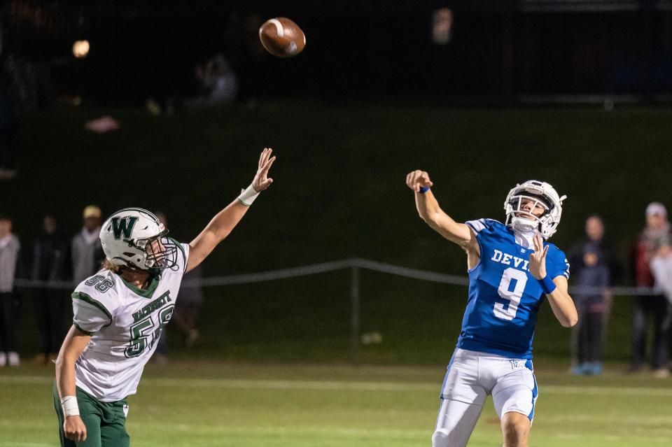 Leominster quarterback Osiris Lopez passes over Wachusett's Blaise Zsidisin.