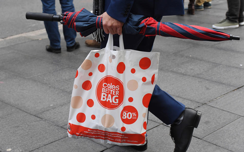 A shopper is seen carrying a reusable plastic bag at a Coles Sydney CBD store shortly after the change in their policy. Image: AAP