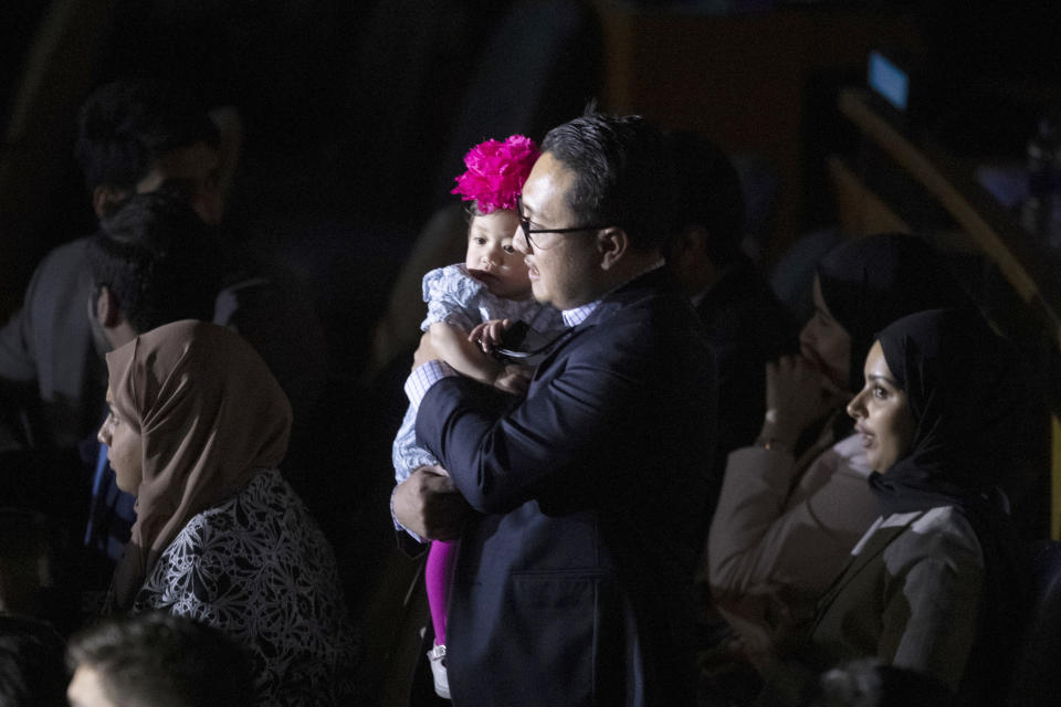 A delegate arrives with his daughter for a High-level meeting on the occasion of the 30th anniversary of the adoption of the Convention on the Rights of the Child, Wednesday, Nov. 20, 2019 at United Nations headquarters. (AP Photo/Mary Altaffer)