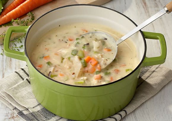 A green pot containing Campbell's vegetable soup.