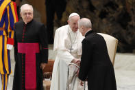 Pope Francis shakes hands with Monsignor Luis Maria Rodrigo Ewart as he arrives in the Paul VI Hall at the Vatican for his weekly general audience, Wednesday, Oct. 28, 2020. A Vatican official who is a key member of Francis’ COVID-19 response commission, the Rev. Augusto Zampini, acknowledged Tuesday that at age 83 and with part of his lung removed after an illness in his youth, Francis would be at high risk for complications if he were to become infected. Zampini said he hoped Francis would don a mask at least when he greeted people during the general audience. “We are working on that,” he said. (AP Photo/Alessandra Tarantino)
