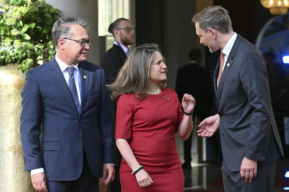 The President of the Bundesbank, Joachim Nagel, left, and German Finance Minister Christian Lindner, right, welcome the Finance Minister of Canada, Chrystia Freeland, center, for a G7 Finance Ministers Meeting at the federal guest house Petersberg, near Bonn, Germany, Thursday, May 19, 2022. (Federico Gambarini/dpa via AP)