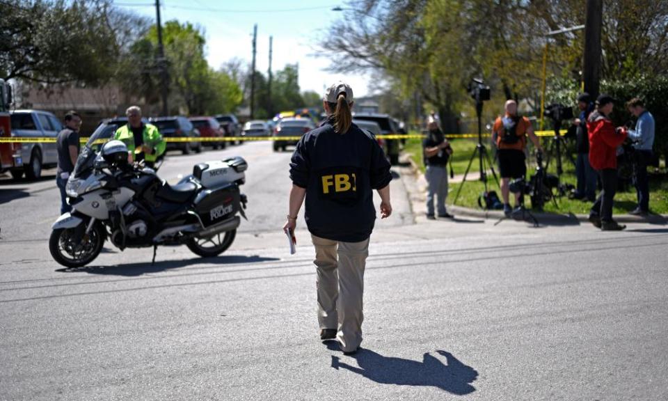 Police investigators at the home where a 17-year-old boy was killed and a woman injured in a package bomb explosion in Austin, Texas on Monday.