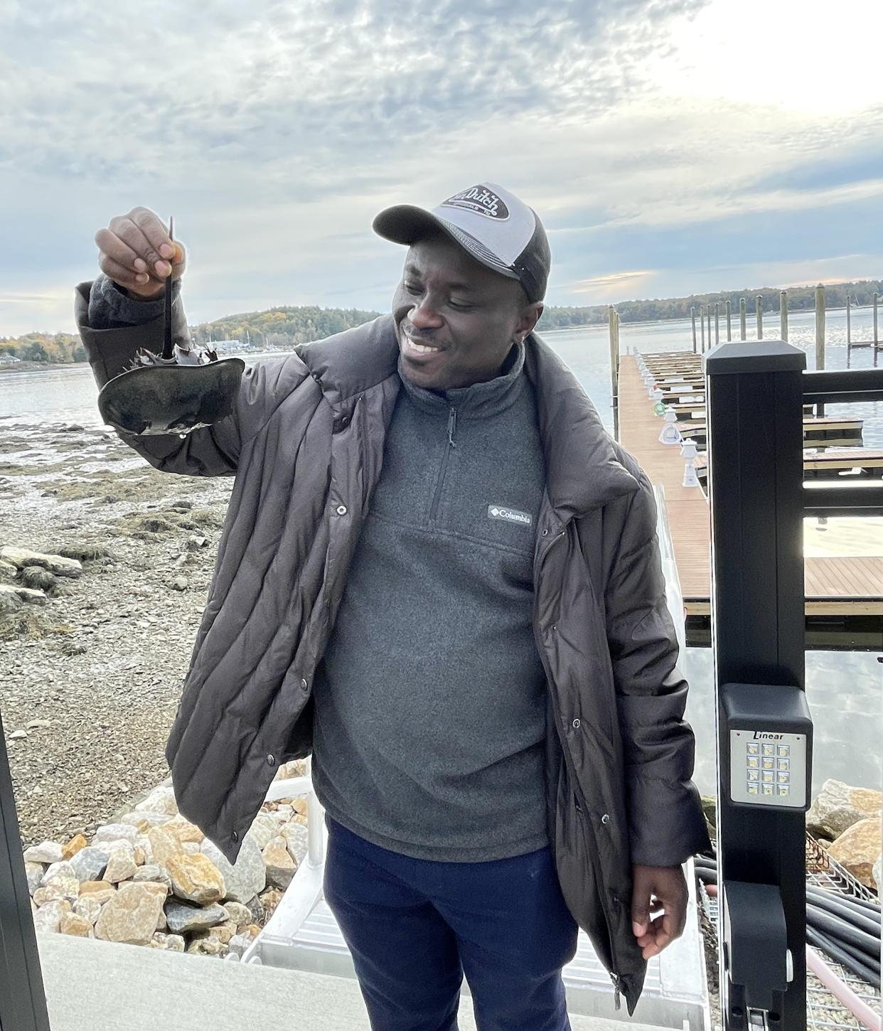 Dr. Dominic Konadu-Yeboah inspects a horseshoe crab on his first trip to New Hampshire.