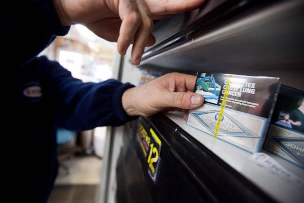 PHOTO: In this file photo, a corner store owner in St. Thomas, Ontario, Canada, holds a package of cigarettes on March 12, 2012. (Geoff Robins/AFP via Getty Images)