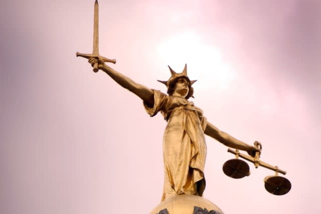 Photograph of the Scales of Justice statue on top of the Old Bailey London UK