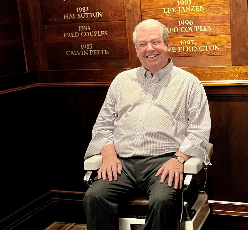 Junior Players Championship chairman Jim McCarthy takes a break in the barber chair located in the TPC Sawgrass locker room.