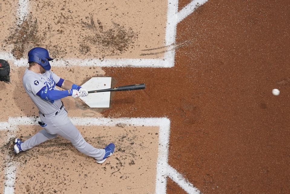 Los Angeles Dodgers' Gavin Lux hits a single during the second inning of a baseball game against the Milwaukee Brewers Thursday, Aug. 18, 2022, in Milwaukee. (AP Photo/Morry Gash)