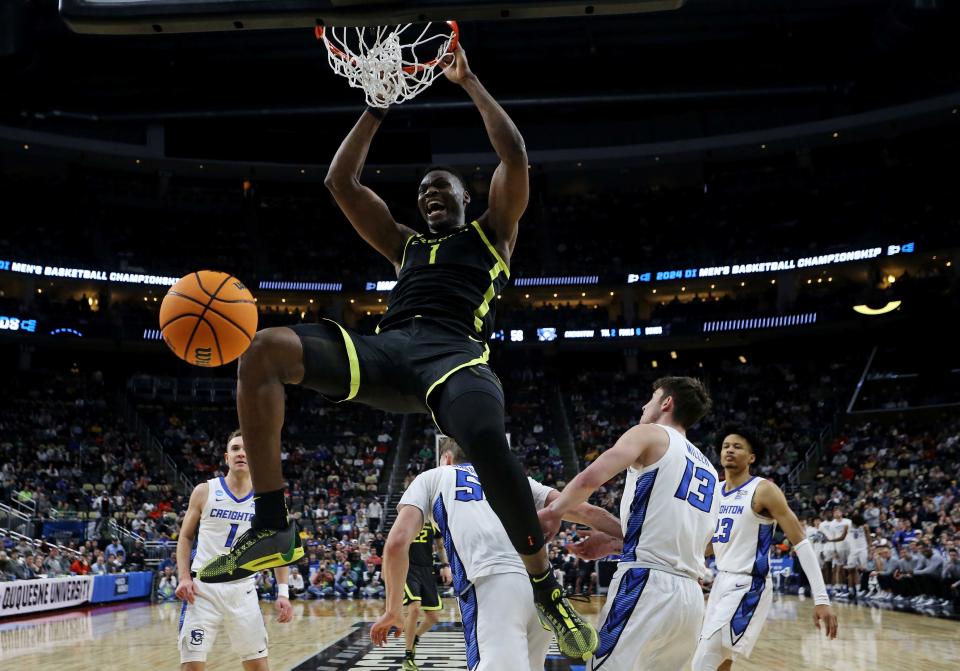 Oregon Ducks center N'Faly Dante (1) dunks the ball against Creighton Bluejays guard Baylor Scheierman (55) in the second round of the 2024 NCAA Tournament at PPG Paints Arena March 23, 2024, in Pittsburgh, Pennsylvania.