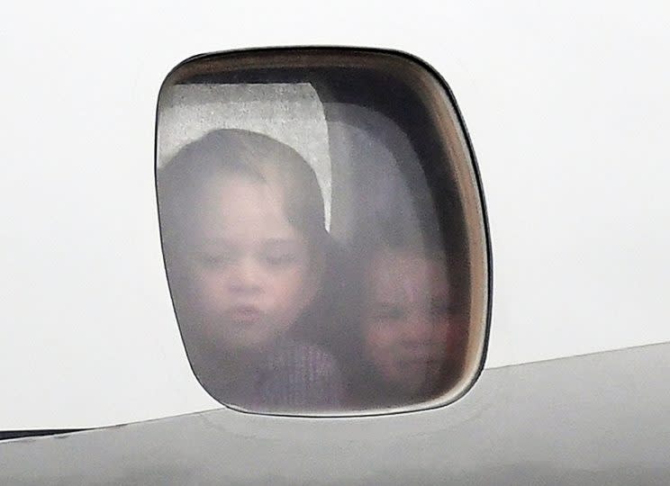 As the plane carrying the family of four arrived in Warsaw, Prince George and Princess Charlotte were seen peeking out a plane window — to the delight of royal fans globally. (Photo: PA)