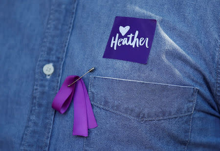 A man wears a purple ribbon to remember Heather Heyer, who was killed at in a far-right rally, as he arrives for her memorial service in Charlottesville, Virginia, U.S., August 16, 2017. REUTERS/Joshua Roberts