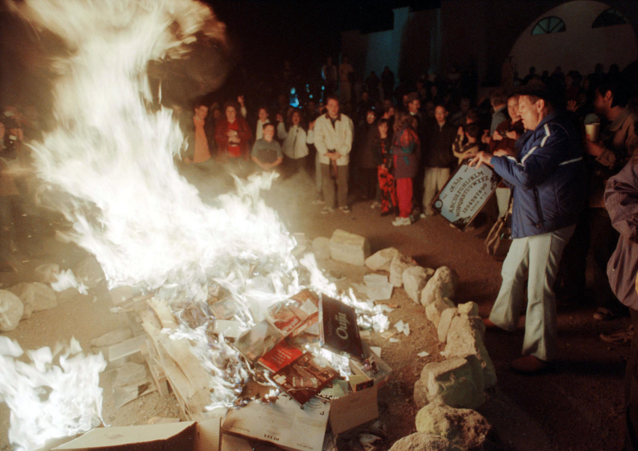 A person tosses a Ouija board into a bonfire outside the Christ Community Church on Dec. 30, 2001, in Alamogordo, N.M. (Photo: Neil Jacobs/Getty Images)