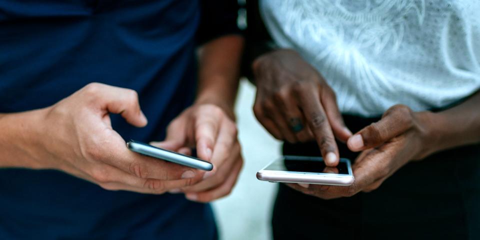 people looking at smartphones texting hands