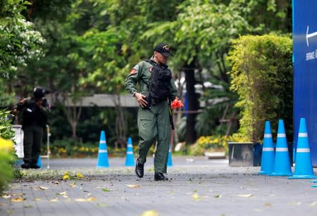 Police Explosive Ordnance Disposal (EOD) officers work following a small explosion at a site in Bangkok
