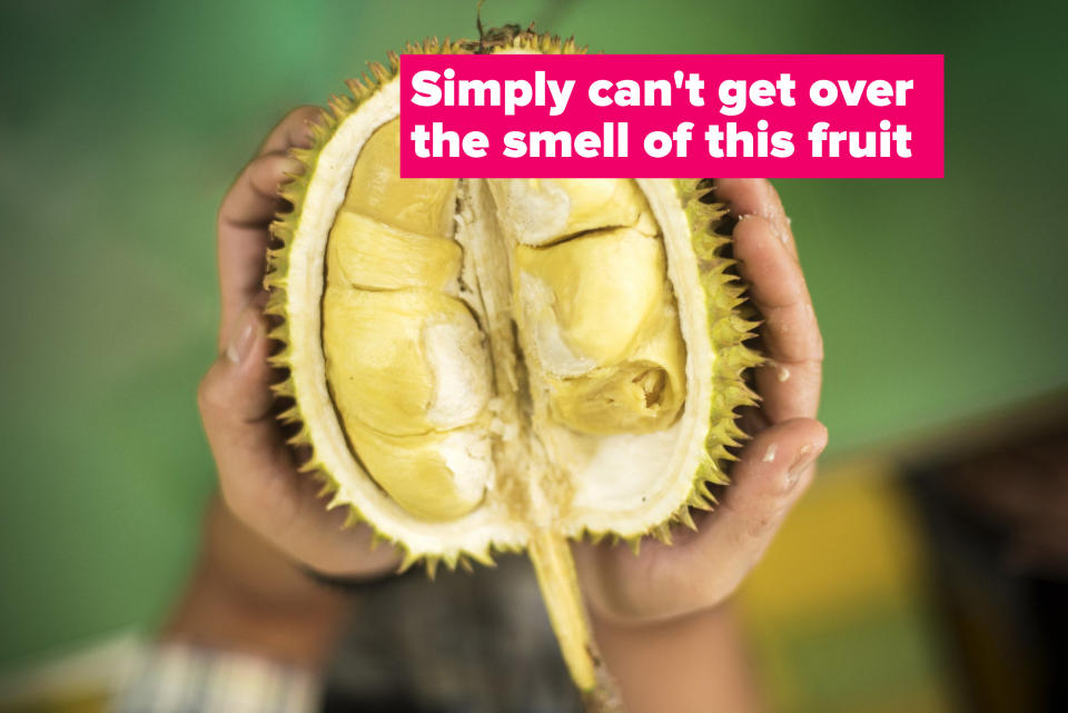 Hands holding a durian