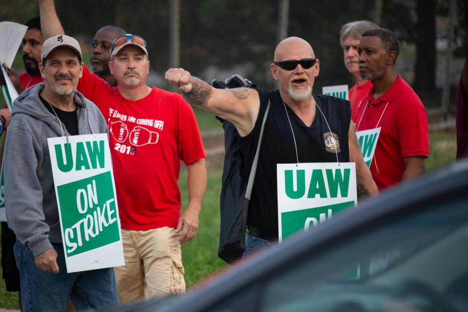 Detroit-Hamtramck Assembly GM Line worker Ralph Payne, 58, of Taylor pumps his fist as a driver honks at strikers with Local 22 take toutside of GM Detroit-Hamtramck Assembly Monday, Sept. 16, 2019.
