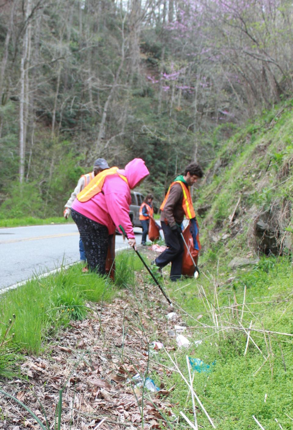 To participate in Earth Day, join a group to pick up roadside litter. In this file photo, volunteers pick up litter along Hayes Run Road in Marshall in Madison County.