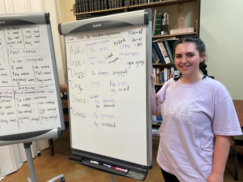 Living Democracy student Payton Davis stands next to her whiteboard after a successful English class for Spanish speakers in Collinsville.