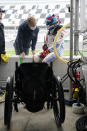 Robert Wickens, right, talks with physical trainer Jim Leo before taking a turn driving during practice for the Rolex 24 hour auto race at Daytona International Speedway, Thursday, Jan. 27, 2022, in Daytona Beach, Fla. (AP Photo/John Raoux)